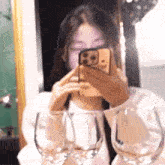 a woman is taking a picture of herself with a cell phone