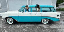 a blue and white car with a picture of a boy and a dog in the window