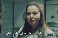 a woman with arabic writing on her face is talking