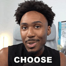 a man in a black tank top with the word choose written on it