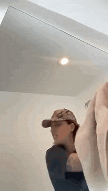 two women are standing in front of a mirror in a bathroom .
