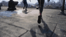 two people running on a rooftop with a city in the background and the letters gb on the bottom