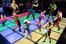 a group of people are dancing on a dance floor and the website lulinternet.com is visible in the corner