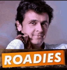 a man is holding a sign that says roads