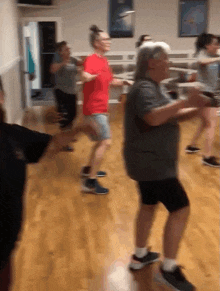 a group of people are dancing together in a room