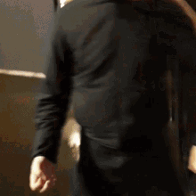 a man in a black shirt is standing in front of a mirror