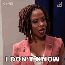 a woman in a pink jacket is saying i don 't know