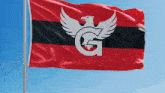 a red black and white flag with a white eagle and the letter g on it