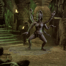 a statue of a woman is dancing in a dark cave