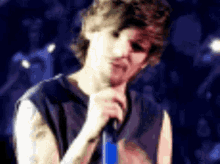 a man is singing into a microphone in a blurry photo