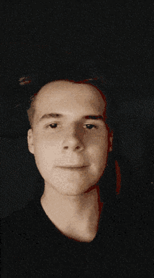 a close up of a man 's face in the dark