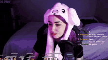 a girl with purple hair is wearing a bunny hat on a stream