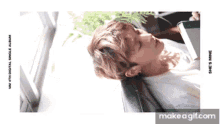 a young man is laying on a couch reading a book ..