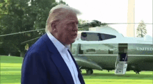 donald trump is standing in front of a united states airplane