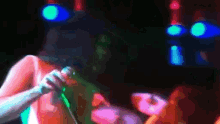 a blurry picture of a woman singing into a microphone in a dark room