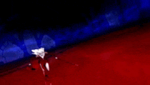 a person is standing on a red carpet in a dark room with a blue light behind them .