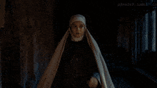 a nun is standing in a dark hallway with the words p3nslv3.tumblr.com above her