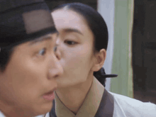 a man and a woman are kissing each other .