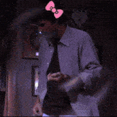 a man in a suit and tie with a hello kitty bow on his forehead