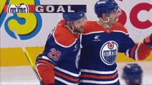 a hockey player with the number 29 on his jersey hugs another player