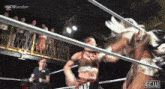 two women are wrestling in a ring with the word london on the bottom right corner