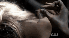 a close up of a person 's hair with the cw logo visible