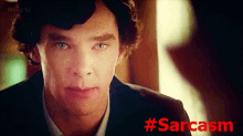 a close up of a man 's face with the word sarcasm in red behind him