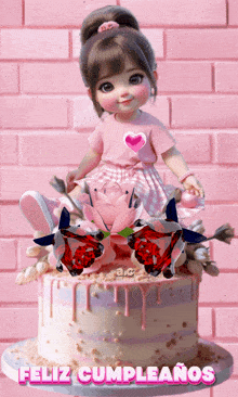 a doll is sitting on top of a cake that says feliz cumpleanos on the bottom