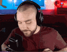 a man wearing headphones and a red shirt