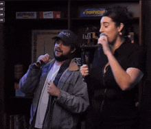 a woman singing into a microphone next to a man with a hat that says smash on it