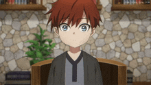 a boy with red hair and blue eyes is sitting in a chair
