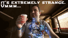a man wearing a storm trooper shirt is holding a drink in his hand