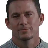 a close up of a man 's face with a gray sweater on