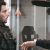 a man in a military uniform is standing next to another man