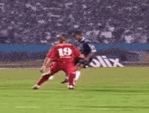 a blurry picture of a soccer player kicking a ball into the goal .