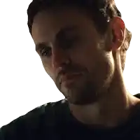a man with a beard is looking down at something