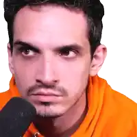 a man with a beard is wearing an orange sweatshirt and looking at the camera
