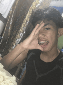 a young man with braces is making a funny face