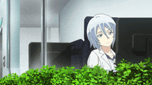 a girl in a lab coat sits in front of a computer