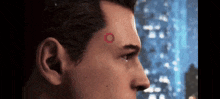 a close up of a man with a red circle on his forehead .
