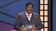 a man in a suit and tie is holding a sign that says " no "