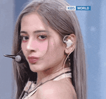 a close up of a woman 's face with a live kbs world logo in the corner