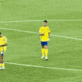 a soccer player wearing a yellow shirt with kafl on it