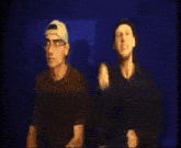 a man in a black shirt is making a funny face with his hands
