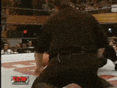 a referee in a wrestling ring with the word ecw on the bottom of the screen