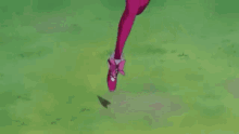 a girl in a pink dress is kneeling on the ground in front of a red object .