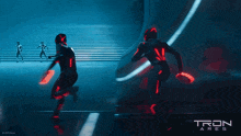 a poster for tron ares shows a group of people in futuristic costumes