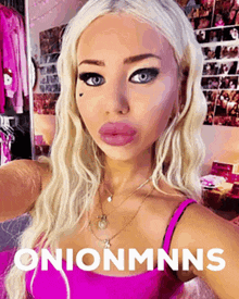 a blonde woman in a pink tank top is taking a selfie with the words onionmnns below her