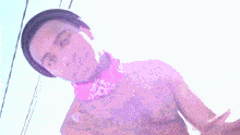 a man without a shirt is wearing a pink choker necklace