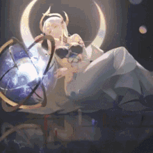 a woman in a white dress is sitting on a table with a globe in her hands .